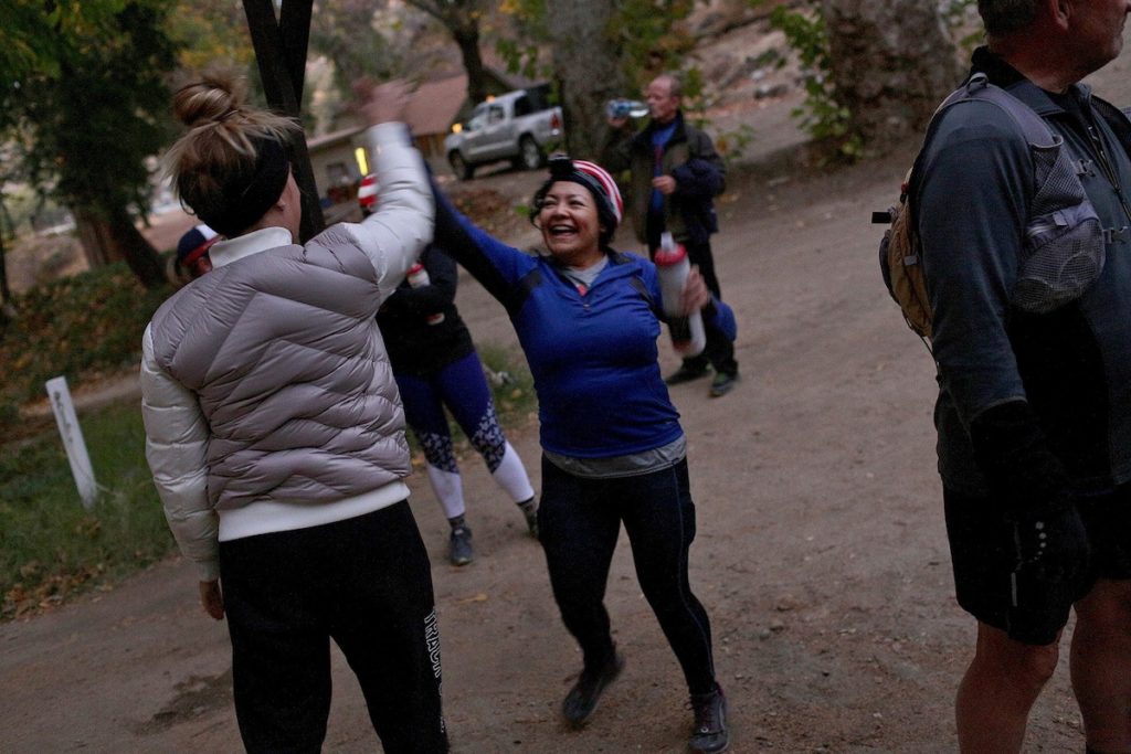 Alma Zavala receives a high-five from a mentor after finishing a trail obstacle course at Band of Runners Trail Camp. PC: Lisa Krantz